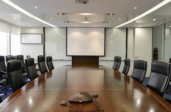 Business board room with white projector screen and IP Phone
