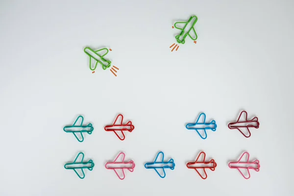 Group of plan paperclip with another two green plane paperclip i