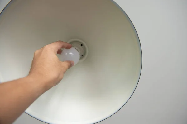 Menschliche Hand wechselt die Glühbirne zu LED für Energiesparkonzept — Stockfoto