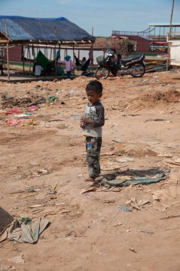 lonely child in a fishermen's village by lake Tonle Sap clipart
