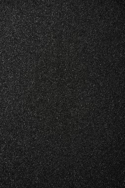 Siyah kum arka plan. Üstten görünüm.