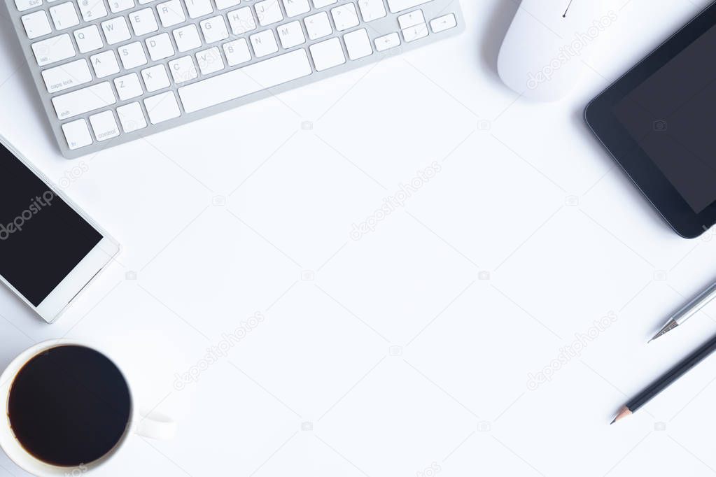 White desk office with laptop, smartphone and other work supplies with cup of coffee. Top view with copy space for input the text. Designer workspace on desk table essential elements on flat lay.