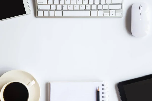 White desk office with laptop, smartphone and other work supplies with cup of coffee. Top view with copy space for input the text. Designer workspace on desk table essential elements on flat lay.