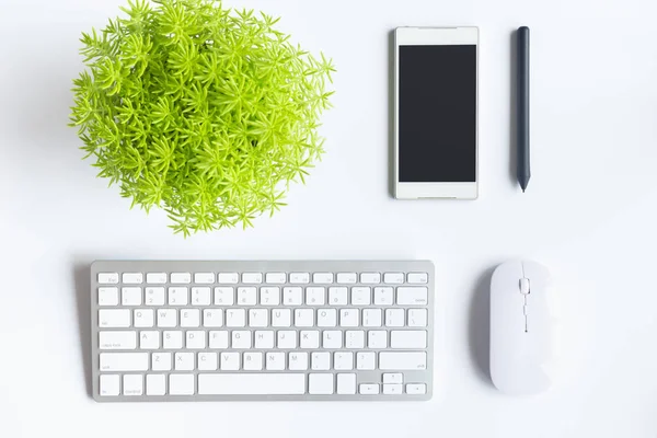 White desk office with laptop, smartphone and other work supplies with cup of coffee. Top view with copy space for input the text. Designer workspace on desk table essential elements on flat lay.