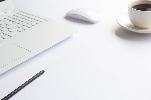 White desk office with laptop, smartphone and other work supplies with cup of coffee. Top view with copy space for input the text. Designer workspace on desk table essential elements on flat lay.