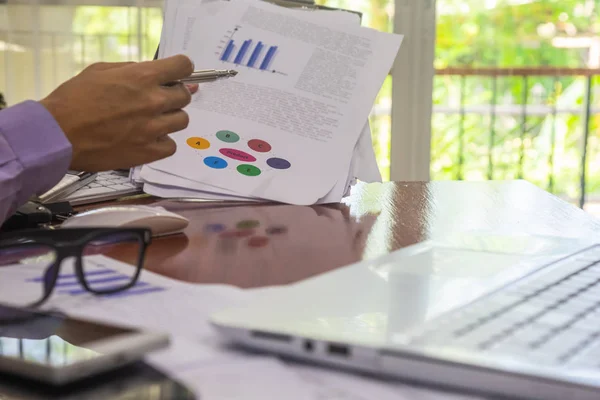 Businessman or accountant working on calculator to calculate bus