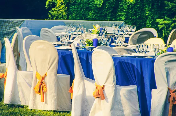 wedding chairs catering table background in garden