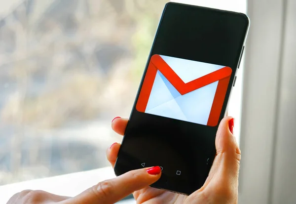 Hand check emails Gmail app by Google on smartphone — Stock Photo, Image