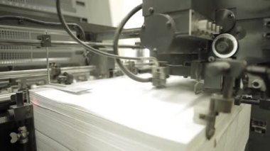 Video kırpmak--dan baskı fabrikası. Makine işleminde kağıt besleme için. Modern ekipman detayları.