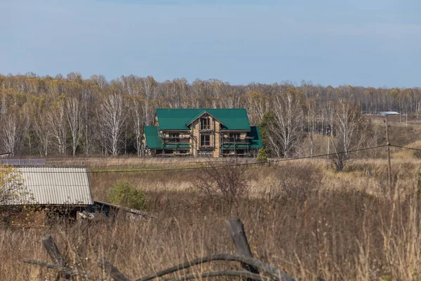 Modern Siberian village. Russian village architecture. The change of seasons. Autumn time in Siberia.