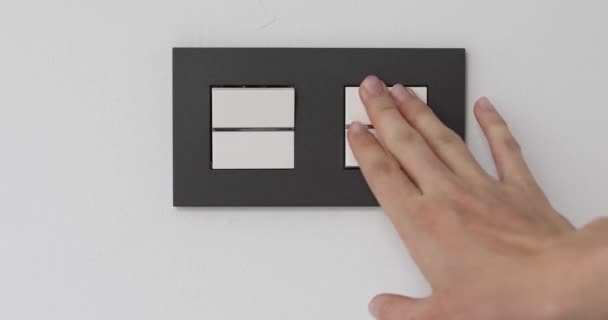 Female hand on light double-switch — Stock Video