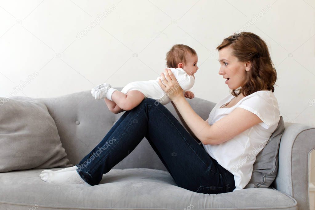 Woman with newborn on sofa