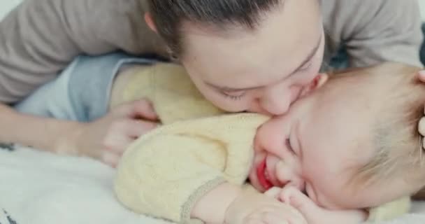 Молода жінка цілує маленького хлопчика — стокове відео