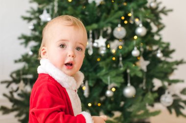 Noel Baba kostüm Noel ağacının yanında duran küçük çocuk