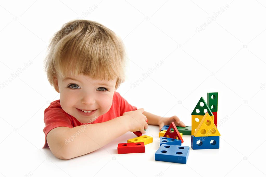 Cute boy building house isolated on white
