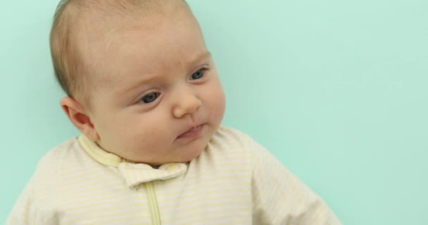 Новорожденная девочка улыбается на розовом фоне — стоковое видео