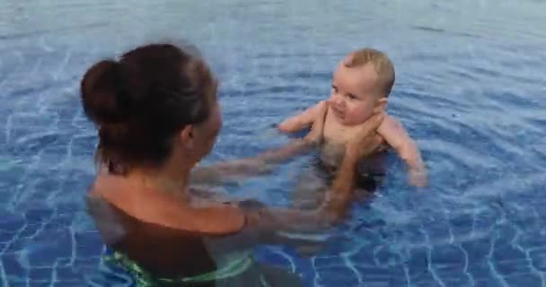 Vrouw met baby in zwembad — Stockvideo