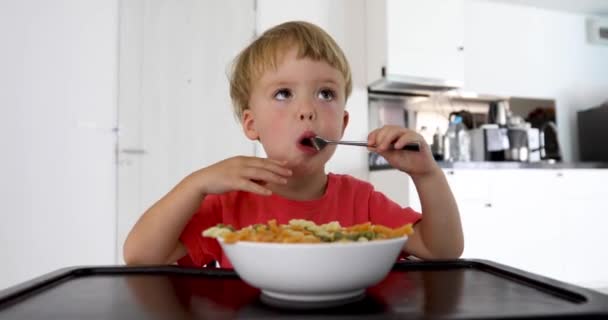Baby child eating spaghetti at home — Stock Video