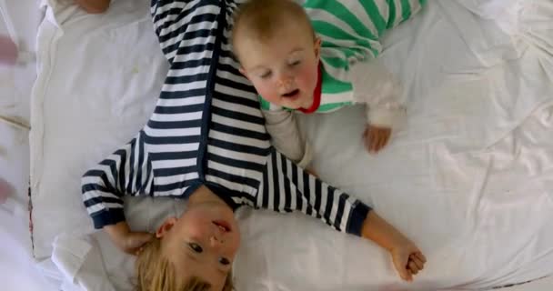 Children striped clothes crib after sleep — Stock Video