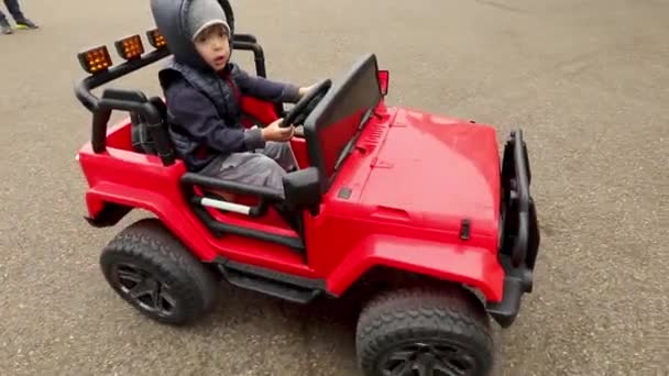 Boy rides on toy car — Stock Video