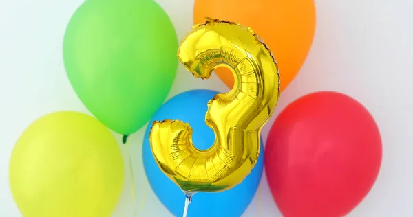 Gold foil number 3 celebration balloon on a color — Stock Photo, Image