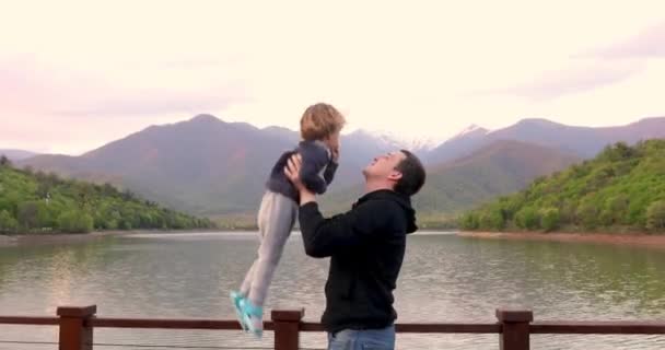 Young Father Playfully Throw Up In Air And Catch Little Child Son — Stock Video