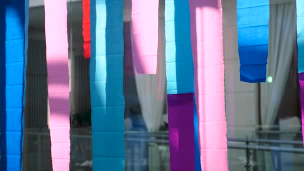 Multicolored stripes hang indoors — Stock Video