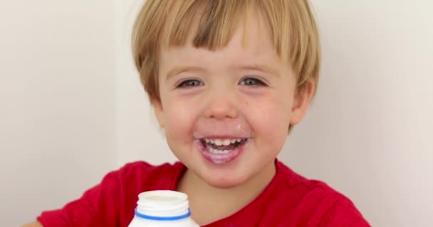 Joyful child drinking yogurt — Stock Video