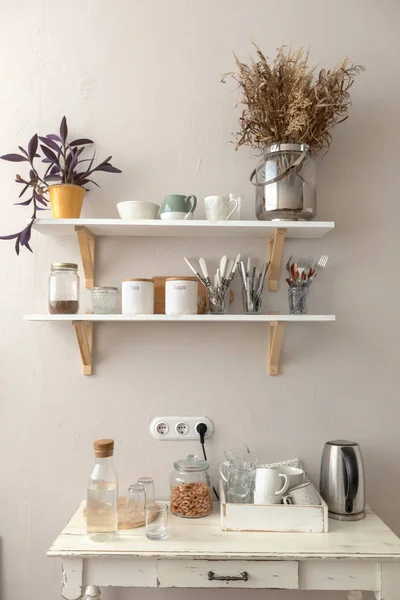 Pots with various houseplants and assorted dishware Stock Photo