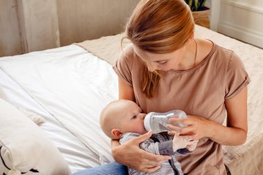 Bebek şişeden su içiyor.