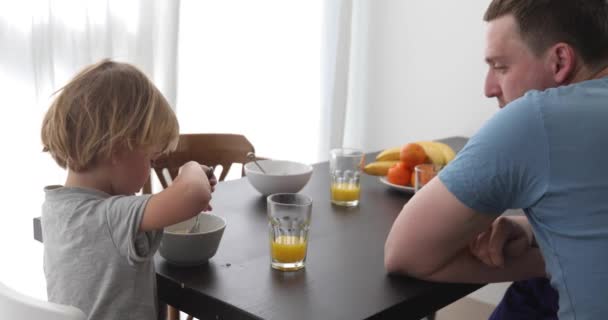 Father and son having breakfast together — Stock Video
