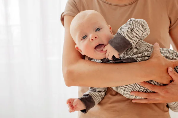 Bambino sfacciato curioso su mani di madre — Foto Stock