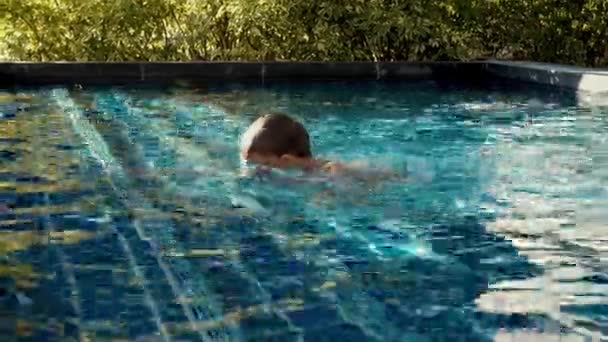 Мальчик плавание в бассейне — стоковое видео