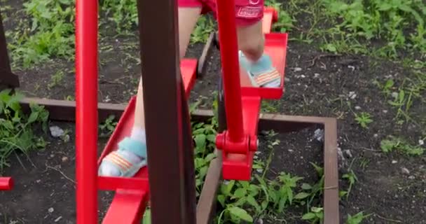 Childs legs on simulator on sports ground — Stock Video