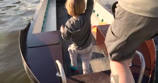 Hombre sosteniendo niño a mano caminando en barco — Vídeo de stock