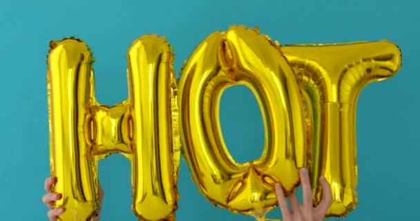 Golden HOT words made of inflatable balloons — Stock Video