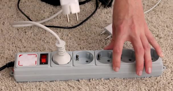 Hands turn on and plug wires from electricity switch — Stock Video