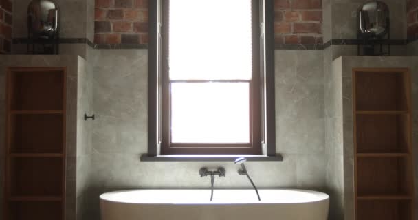 Modern acrylic soaking bathtub with hand shower — Stock Video