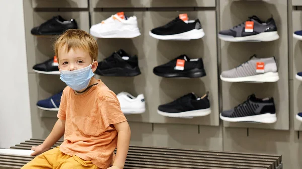 Băiat în mască în magazin de pantofi — Fotografie, imagine de stoc