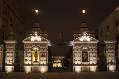 Warsaw, Poland - February 24, 2018: The Main Gate to the University of Warsaw designed by Stefan Szyller in Neo-Baroque style at night in Warsaw, Poland  clipart