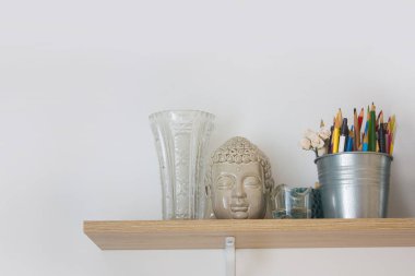 Kurşun kalem, fırça ve Buda baş artist's Studio ile ahşap raf
