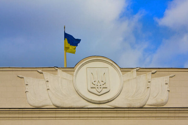 Kyiv, Ukraine - February 17, 2019: Fragment of building of Ukrainian Parliament (Verkhovna Rada) with flag and symbols (trident) of Ukraine in Kyiv 