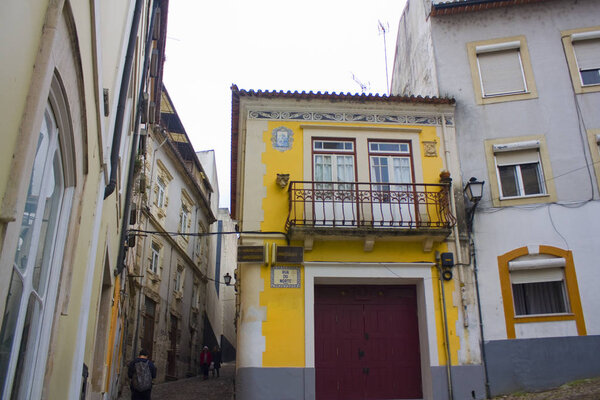 COIMBRA, PORTUGAL - March 1, 2019: Picturesque street with ancient houses in Old Upper Town of Coimbra
