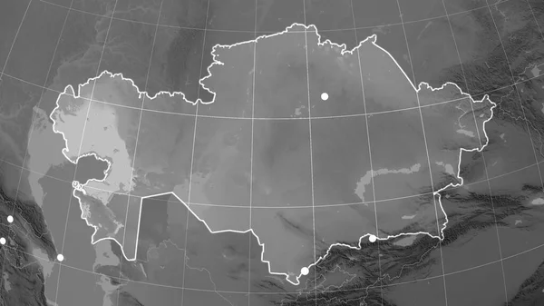 Kazakhstan outlined on the grayscale orthographic map. Capital, administrative borders and graticule