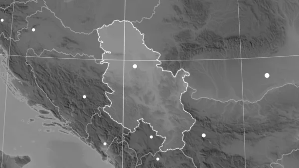 Serbia outlined on the grayscale orthographic map. Capital, administrative borders and graticule