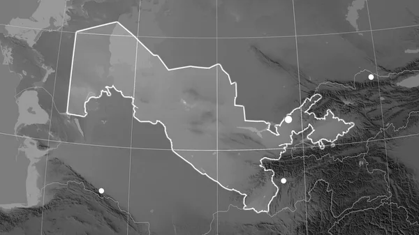 Uzbekistan outlined on the grayscale orthographic map. Capital, administrative borders and graticule