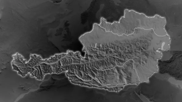 奥地利面积扩大了 并在其周围环境的黑暗背景下闪烁着光芒 灰度隆起地图 — 图库照片