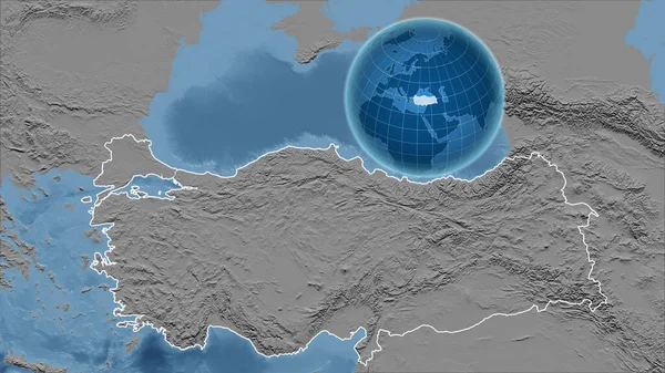 Turkey. Globe with the shape of the country against zoomed map with its outline. grayscale elevation map