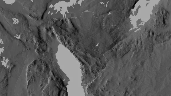 Njombe, region of Tanzania. Grayscaled map with lakes and rivers. Shape outlined against its country area. 3D rendering