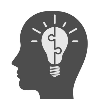 Beyaz üzerine izole bulmaca parçalarından yapılmış ampul ile baş simgesi